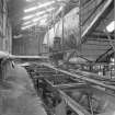 Interior view of the refinery Steam Accumulator, used for storing steam for the process.  Visible in the foreground is the old railway siding used in the past for supplying coal to the Boiler House (T&L No.: 21178/3)