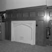 Ground floor, reception area, fireplace with wood panelling surround, detail.