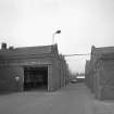 Motherwell, Craigneuk Street, Anderson Boyes
Exterior view from south showing to left the entrance to east side of large block of Machine Shops (built 1943 to 1957), and to right, range of stores (built 1955)