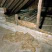 Roof space, floor, timber partition filled with moss, detail