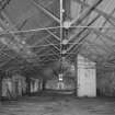 Interior.
View of attic of high mill, showing wrought-iron roof trusses, and top of lift shaft (added when building was converted to bonded warehouse).