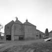 General view of mill from N, showing two kilns in foreground.