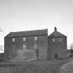 View of mill from E, showing main block of mill on left, and kilns on right.  A single-storeyed building attached to the E side of the mill has been recently demolished.