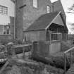 General view from SW of water wheel house, showing sluices controlling water flow to wheel house and to by-pass lade.