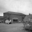 General view from E, showing the former granary block forming the E side of the building (now used as workshop and store for cabinet maker, but previously converted to ice store for white fish following erection of fish processing works on W side in 1896)