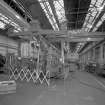 Motherwell, Craigneuk Street, Anderson Boyes
Fitting Shop (Dept. 51, built 1962): Interior view at N end of west bay from N, showing a newly-assembled Roof-bolting Machine with jib extended, undergoing tests prior to dispatch