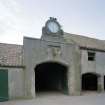 Athelstaneford Mains.
Detail of main entrance in N side of steading, showing clock, 1860 date and bovine sculpture.