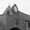 Athelstaneford Mains.
Detail of clock and bovine sculpture above main entrance in N side of steading, with wind vane in background.