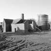 View of threshing barn and grain silo from North East.