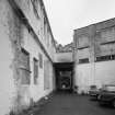 Edinburgh, West Mill Road, West Mills.
Detailed view from NE between two two-storeyed ranges, in use as show rooms.