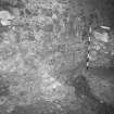 Excavation photograph : area A - light coloured mortar spreading over fragment of footing 14 and bedrock, sealed by walls 12 and 13.