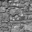 Detail of stone with blocked circular opening in East wall.
