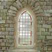 Detail of leaded glass window in E wall of church