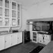 Ground floor kitchen, view from North showing original cabinets