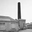 View from NW of boilerhouse chimney and enginehouse, beam engine house with cast iron roof tank by G. Graham of Carlisle.