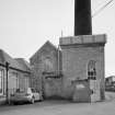 View from NW of steam engine houses, the beam engine house on the right having a cast iron roof tank made by G. Graham of Carlisle.  Also visible is the base of the boilerhouse chimney.