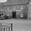 View of front elevation of Commercial Hotel, High Street, Falkland with parked car