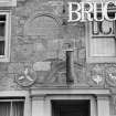 View showing panels above entrance of Bruce Arms Inn, High Street, Falkland, including one inscribed 'B W 1607'