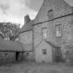 View from East showing rear wing of main house, kitchen wing and timber porch