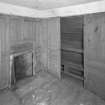 Interior. View of second floor East room/housekeepers room from North showing fireplace and fitted cupboards.