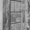 Detail of tmber panelling on porch designed to look like ashlar stonework