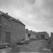 View from W of weaving sheds forming NE end of the works, with old air raid shelter (centre left).