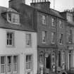 View of 5 and 6 Abbey Place, Jedburgh, from west, showing part of Abbots Lea and T Cairncross confectioner and tobacconist.