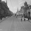 View of Union Street, Aberdeen showing bicycles and tram
