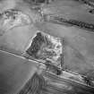 Oblique aerial view centred on the remains of the quarry, taken from the SW.