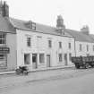 General view from north of 23-29 Newtown Street, Duns, showing the premises of Thomas Darrie groceries and provisions and Dursi Ltd Electrical Services