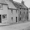 View of houses on Main Street, Abernethy, one in state of disrepair. Demolished 1966.