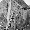 View of houses on Main Street, Abernethy, including a thatched roofed cottage in state of disrepair. Demolished 1966.