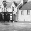 View of Main Street, Glenluce showing Ardville and the premises of a photography shop and John McHarrie, joiner and funeral undertaker, from east.