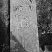 View of graveslab with initial 'I M' and 'M H' in the churchyard of Clackmannan Parish Church.