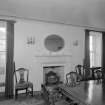 Interior view of Corsindae House showing dining room with fireplace.