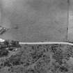 Oblique aerial view of Clach Chairidh Pictish symbol stone, Ederton and the site of Carriblair stone circle.