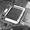 Oblique aerial view centred on the football stadium, taken from the SSE.