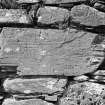 Detail of incised stones on South wall.