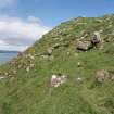 Eigg, Poll Duchaill, Fort. View from S of fragment of W wall.