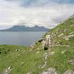 Eigg, Poll Duchaill, Fort. View from S of fragment of W wall.