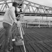 View of Steve Wallace, RCAHMS, using video camera recording at Kincardine Bridge.