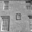 Detail of Gardyne Castle showing heraldic panel and windows from S.