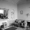 Interior view of Cairness House showing room to right of entrance hall with fireplace.

