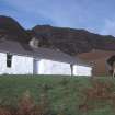 Eigg, Grulin Uachdrach, Township. View of Ian Parker using a plane table outside the shepherd's cottage at Grulin Uachdrach.