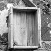 View of wooden cabinet on W wall, formally containing carved stone, St Donnan's Church, Kildonnan, Eigg.