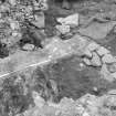 Excavation photograph showing entrance way, post holes and timber 'floor'

