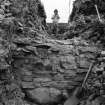 Excavation photograph showing excavation team at work-outside wall layering

