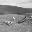 Excavation photograph showing members of the excavation team at work - view across Strath Oykel
