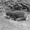 Excavation photograph showing members of the excavation team at work;
30. director(H.N.) beside external wall layering

