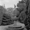 View of fountain and surrounding shrubbery in garden of Ravelston House, Edinburgh.